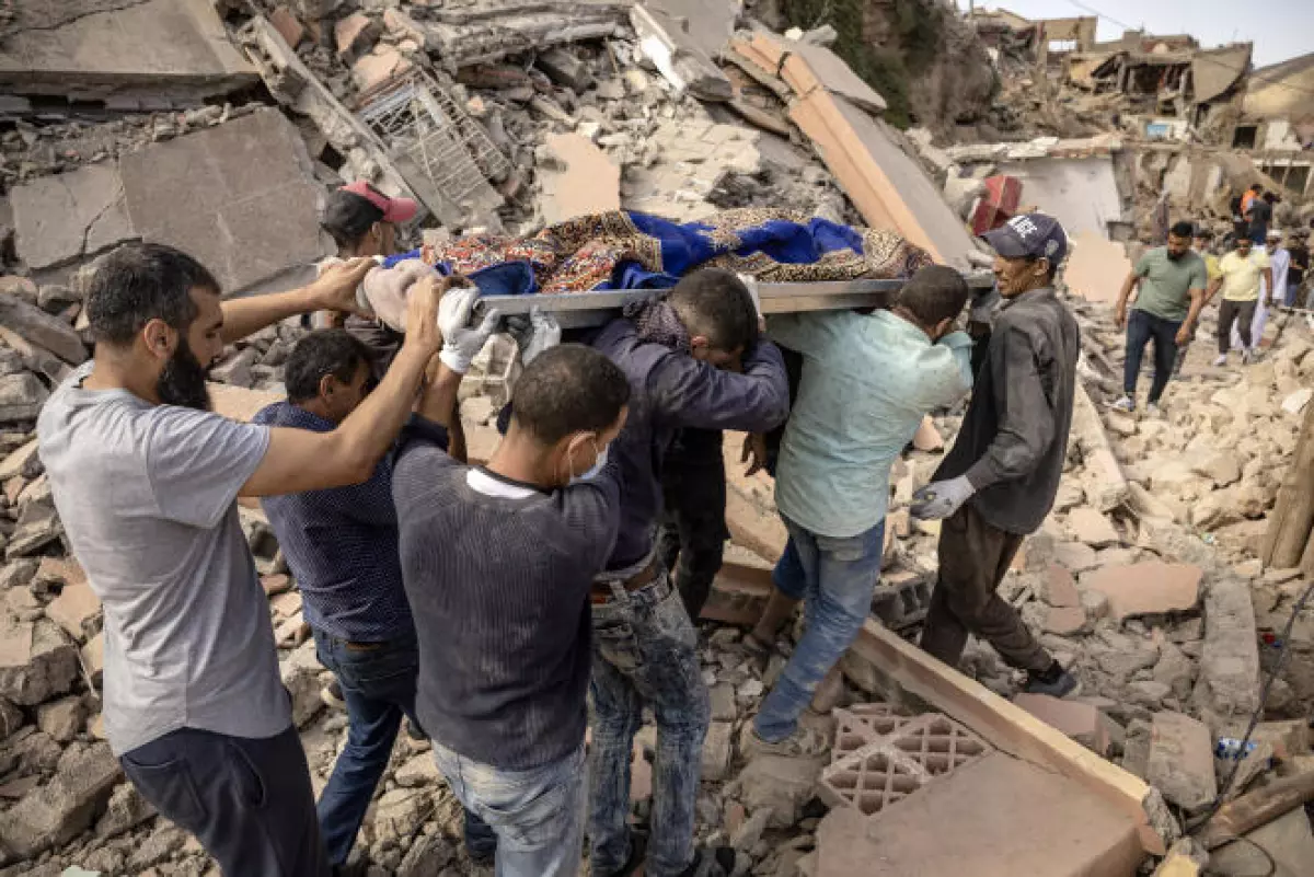 Des habitants d’Imi N’Tala, au Maroc, transportent le corps d’une victime du séisme, le 10 septembre 2023.